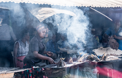 Our driver stopped for a bite at one of the roadside stands.  I was enamored with this woman stacking and smoking fish.